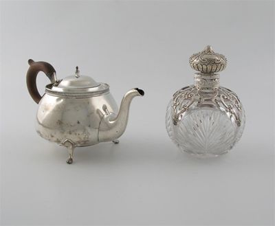 Appraisal: A modern squat circular teapot on paw feet with a