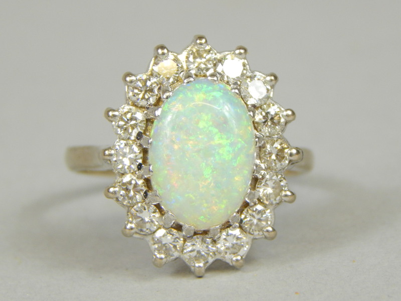 Appraisal: An opal and diamond ring with cabochon opal measuring mm