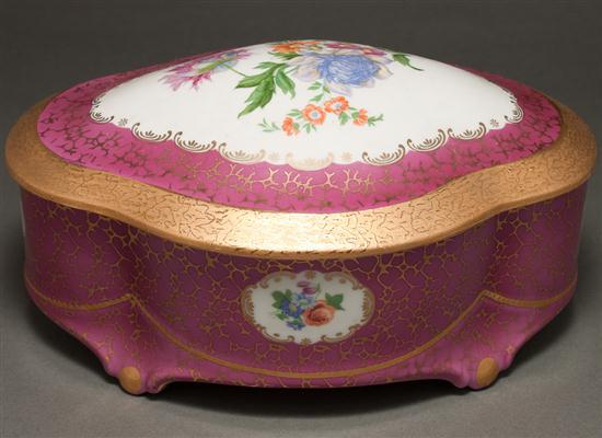 Appraisal: German painted parcel-gilt porcelain covered dresser box th century lobed