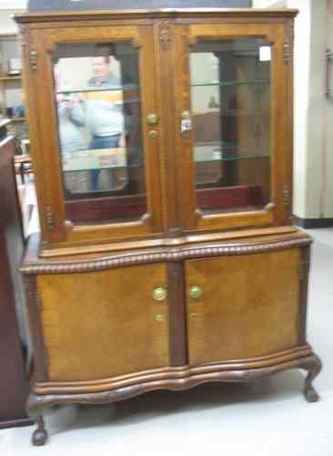 Appraisal: AN OAK AND MAHOGANY CHINA CABINET ON CABINET Continental mid-