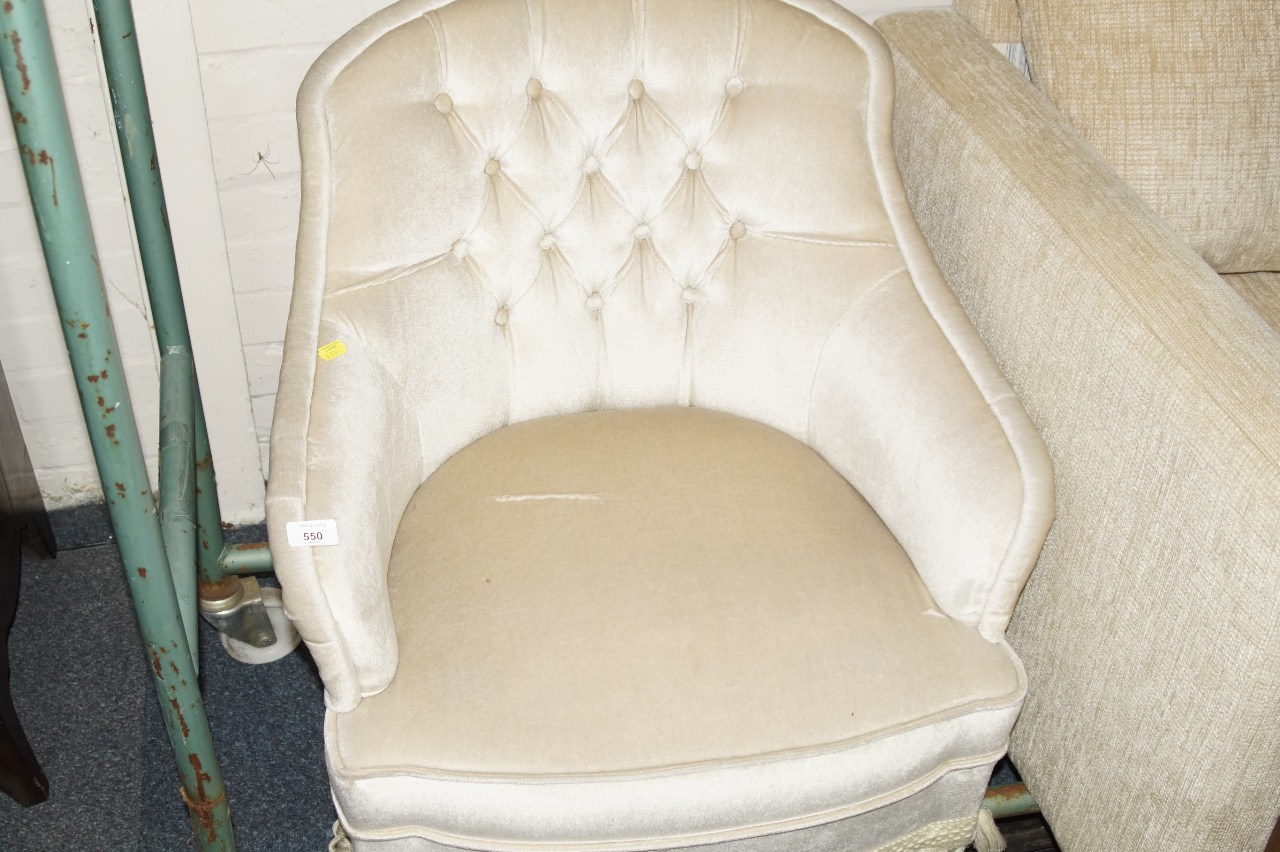 Appraisal: A button back upholstered tub chair in cream dralon