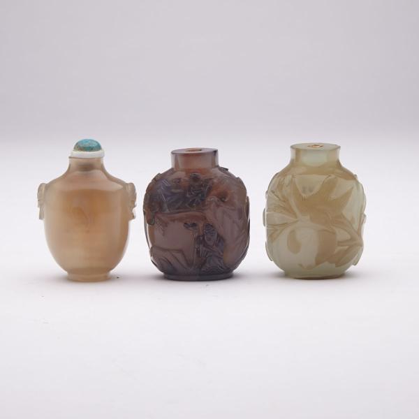 Appraisal: Three Agate Carved Snuff Bottles One carved with scenes of