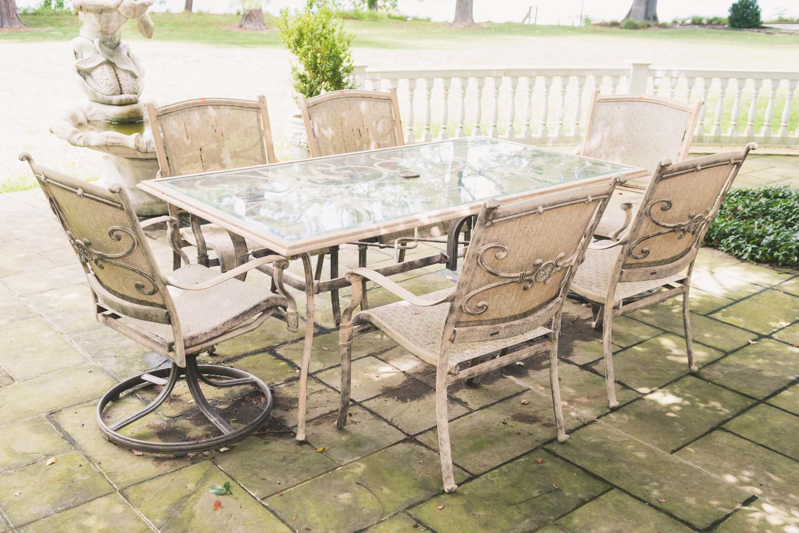 Appraisal: Classical style painted metal patio set comprising rectangular glass top