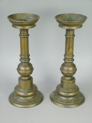 Appraisal: A pair of Continental bronze pricket candlesticks on turned columnar