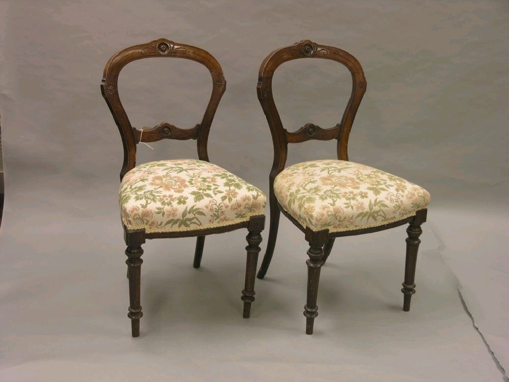 Appraisal: A set of four Victorian walnut balloon-back dining chairs frames