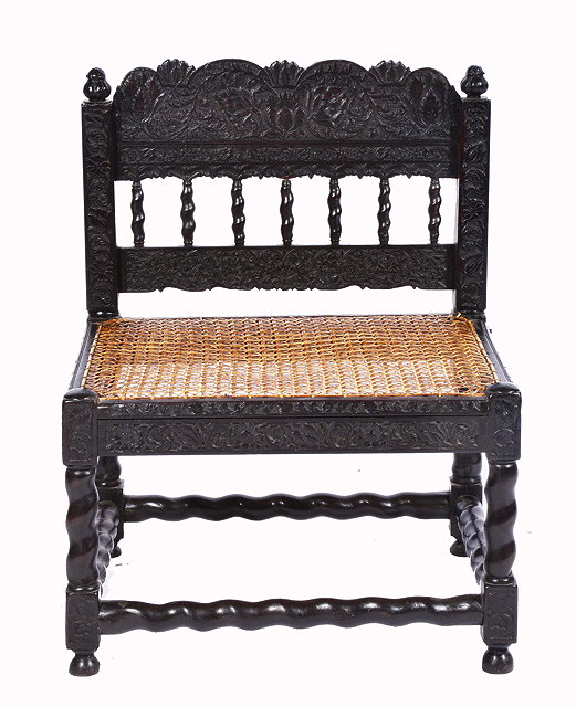 Appraisal: AN EARLY TH CENTURY INDO-PORTUGUESE EBONY LOW SIDE CHAIR with