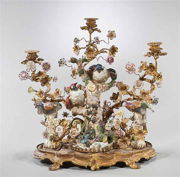 Appraisal: Gilt bronze and porcelain three-light candelabra in the form of