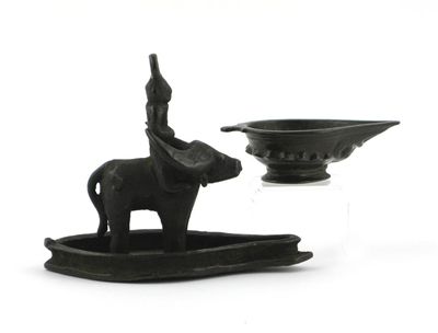 Appraisal: Two bronze Indian oil lamps one cast as a figure