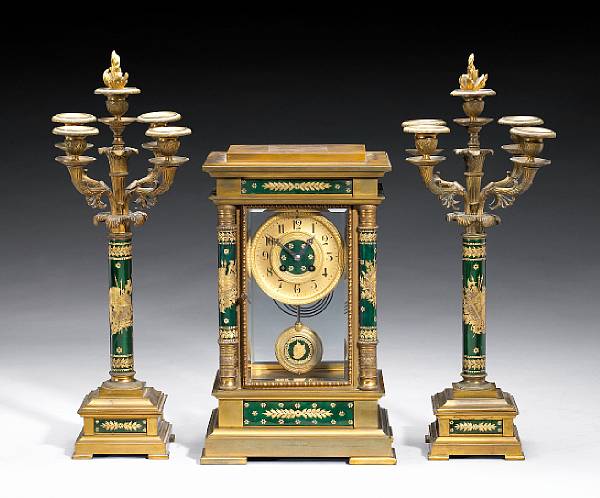 Appraisal: A French gilt bronze and enamel three piece clock garniture