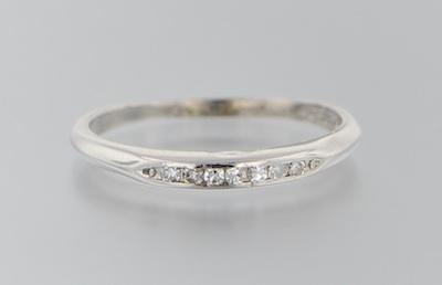 Appraisal: A Platinum and Diamond Band Platinum band features seven channel