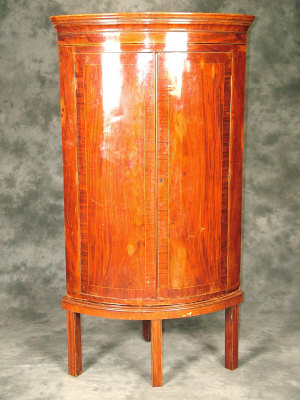 Appraisal: A George III mahogany bowfront corner cabinet on stand circa