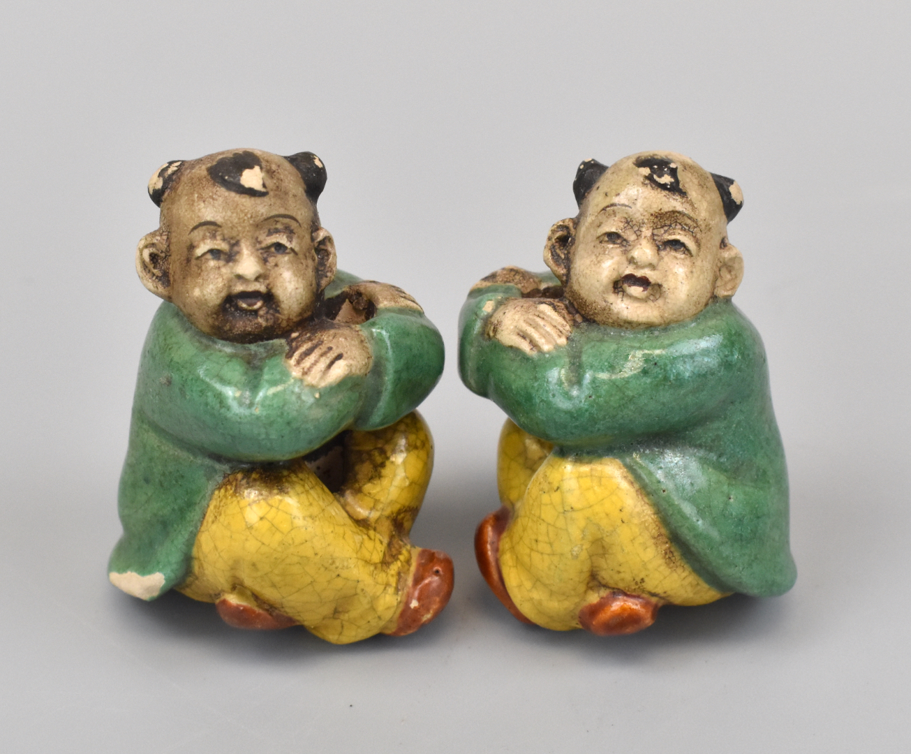 Appraisal: A pair of diminutive Chinese porcelain figures of boys sitting