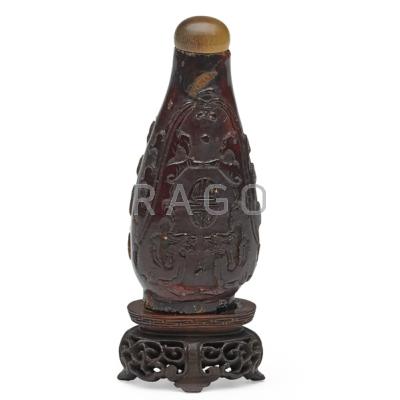 Appraisal: CHINESE AMBER SNUFF BOTTLE Dragon decoration in relief with lid