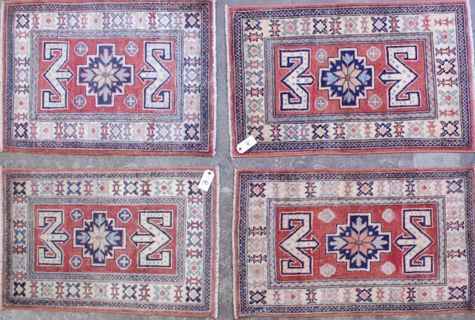 Appraisal: FOUR HAND KNOTTED ORIENTAL AREA RUGS Pakistani Caucasians identical patterns