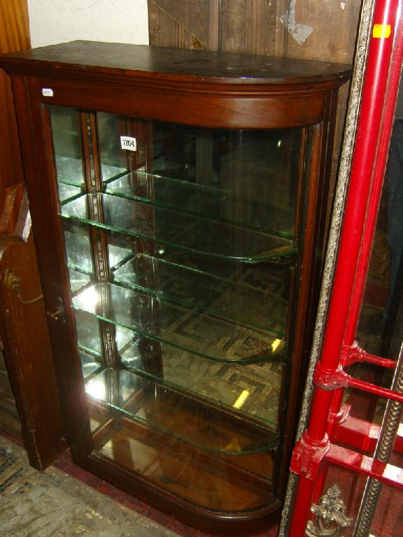 Appraisal: A Victorian mahogany shop display cabinet enclosed by a single