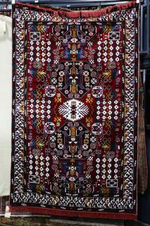 Appraisal: Modern machine made carpet decorated with stylized native figures '