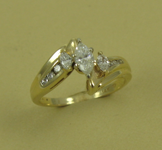 Appraisal: DIAMOND RING K yellow gold setting featuring three marquise-cut and