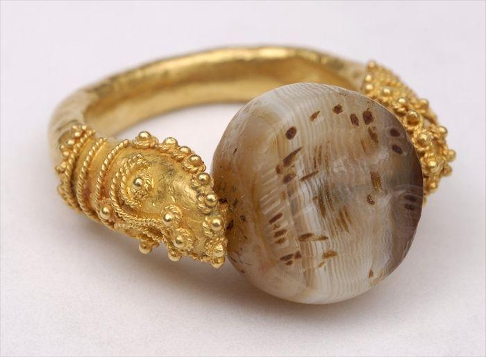 Appraisal: PARTHIAN-STYLE HARDSTONE MOUNTED IN A FILIGREE AND CRENELATED SWIVEL RING