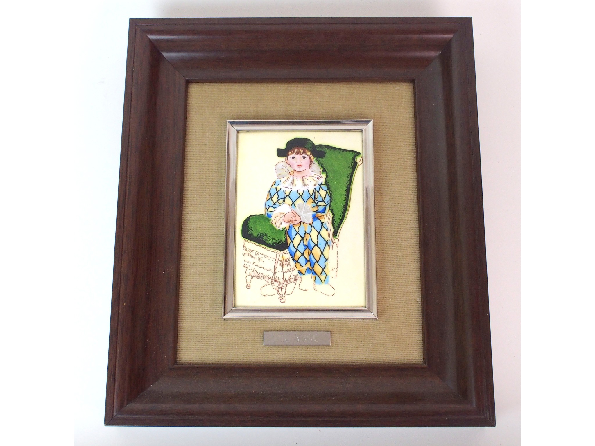 Appraisal: A framed enamelled plaque after Pablo Picassodepicting a child harlequin