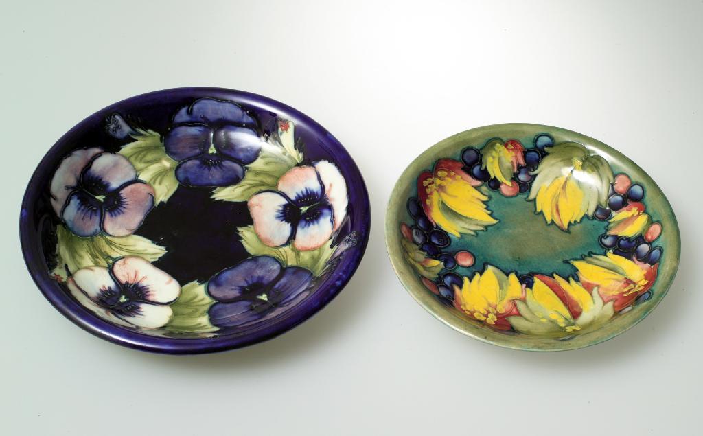 Appraisal: WILLIAM MOORCROFT POTTERY PLATE tubelined and hand painted with pansies