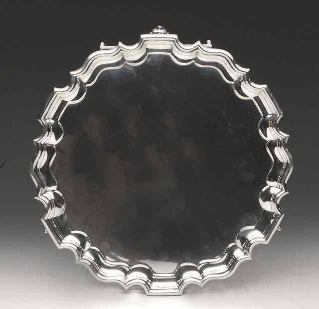 Appraisal: A SILVER SALVER with a Chippendale border and standing on