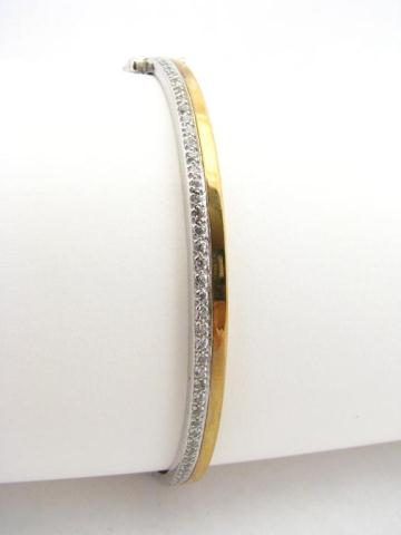 Appraisal: A K white and yellow gold hinged bangle bracelet with