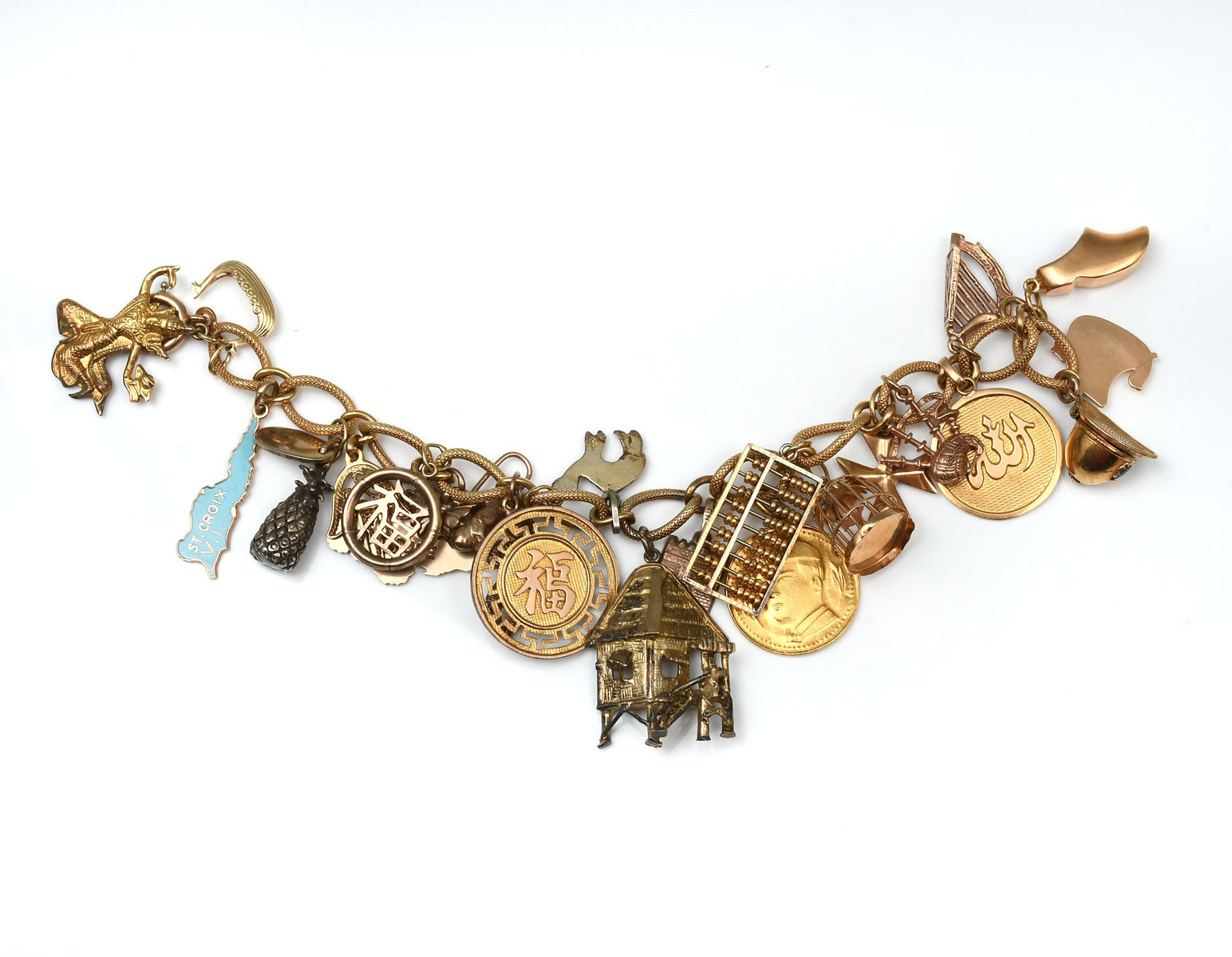 Appraisal: K CHARM BRACELET AND CHARMS '' yellow gold bracelet has