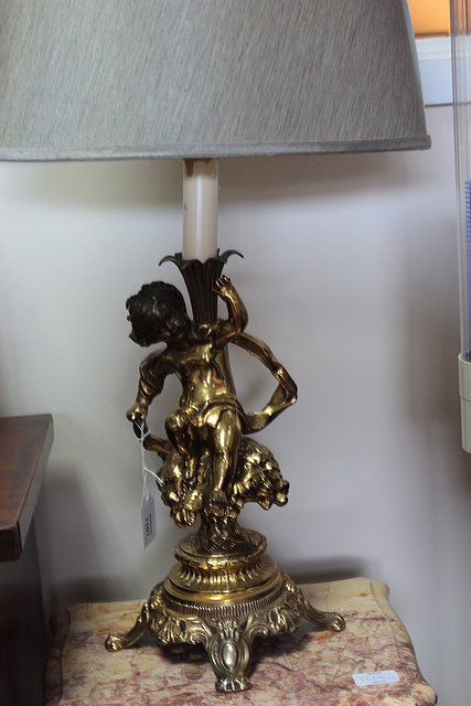 Appraisal: A PAIR OF GILT METAL TABLE LAMPS with putti supports