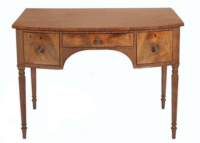 Appraisal: A GEORGE IV MAHOGANY BOWFRONTED WRITING OR DRESSING TABLE fitted