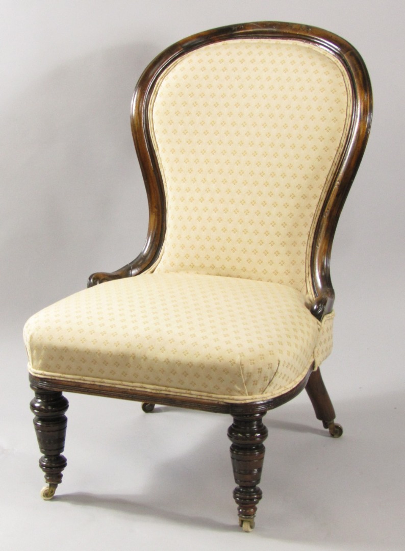 Appraisal: A Victorian oak balloon back nursing chair upholstered in overstuffed