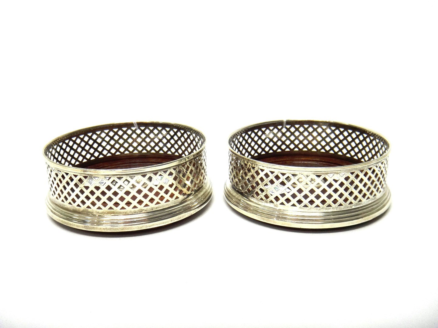 Appraisal: A pair of silver bottle coasters each of circular form