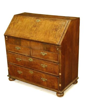 Appraisal: A walnut bureau cross and feather banded the hinged fall