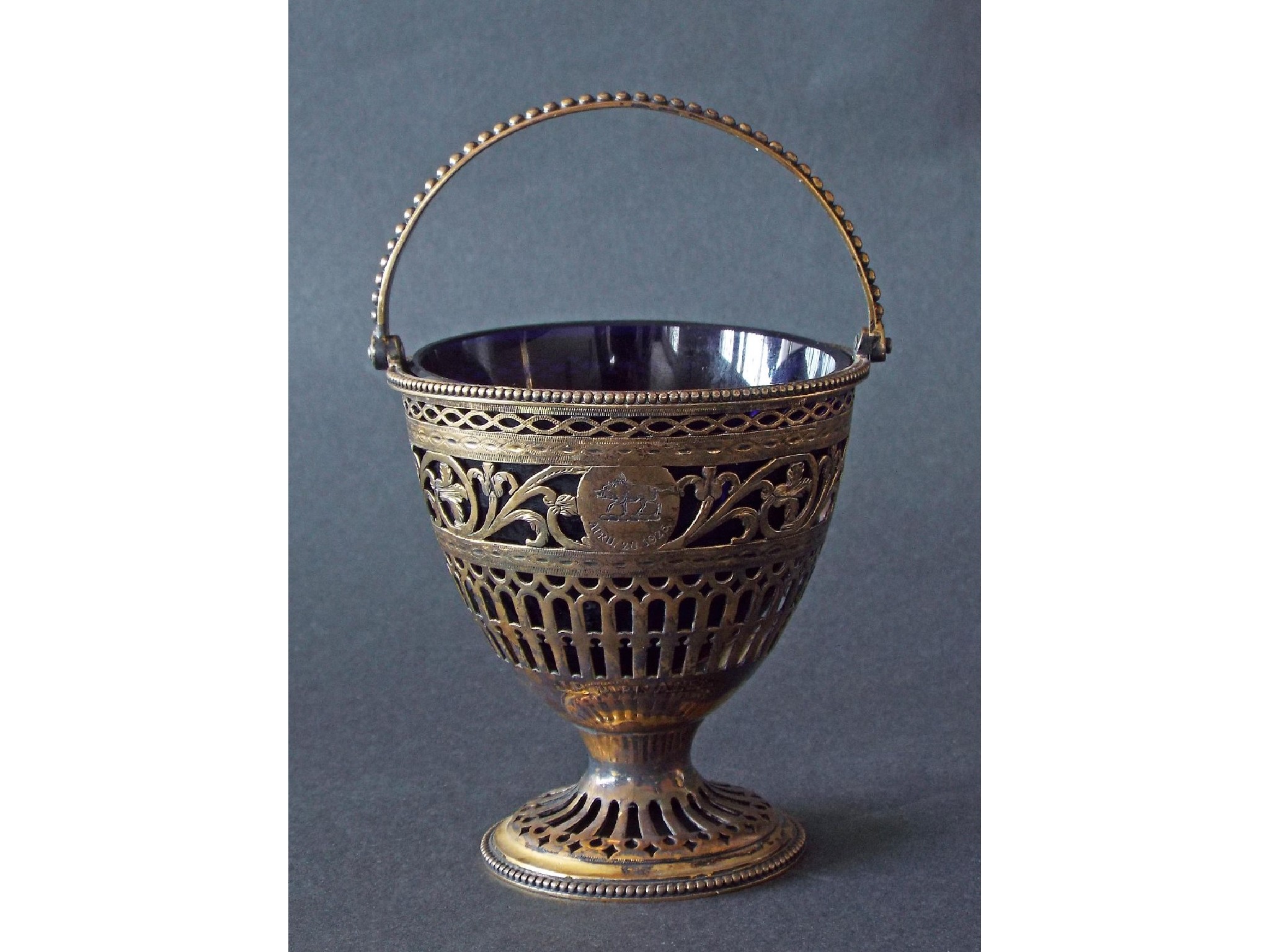 Appraisal: George III silver-gilt basket with beaded swing handle over pierced