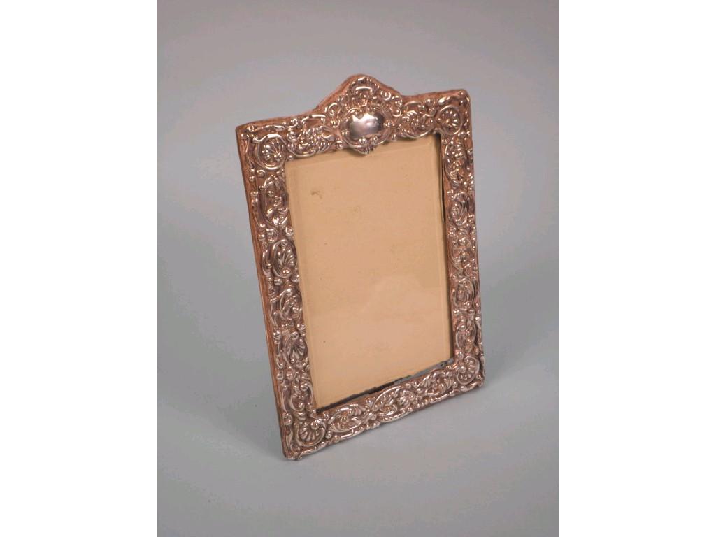 Appraisal: An Edwardian silver photograph frame with an embossed border on