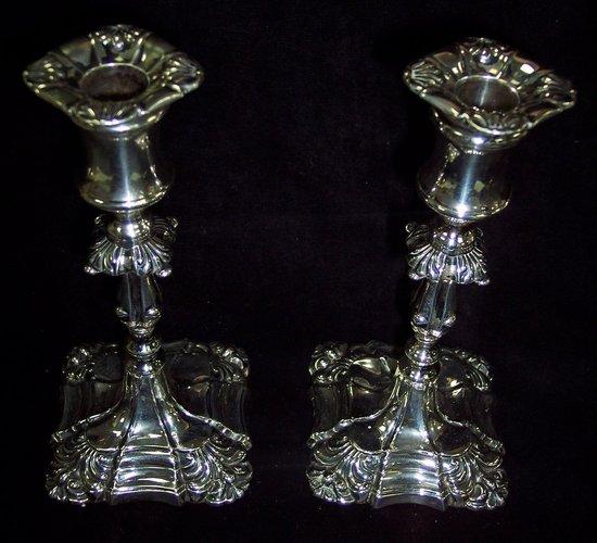 Appraisal: A pair of Georgian style candlesticks Walker and Hall Sheffield