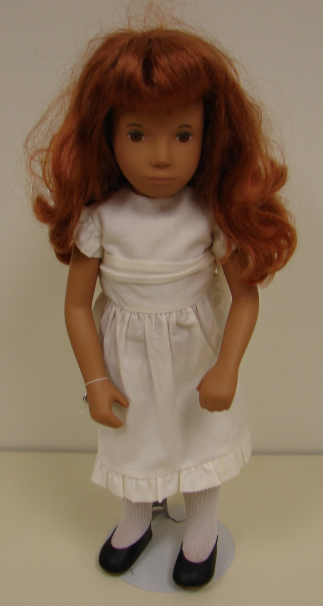 Appraisal: Auburn female doll dressed in original clothing White dress tights