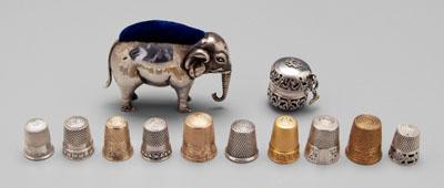 Appraisal: silver and gold sewing items English silver elephant pincushion sterling