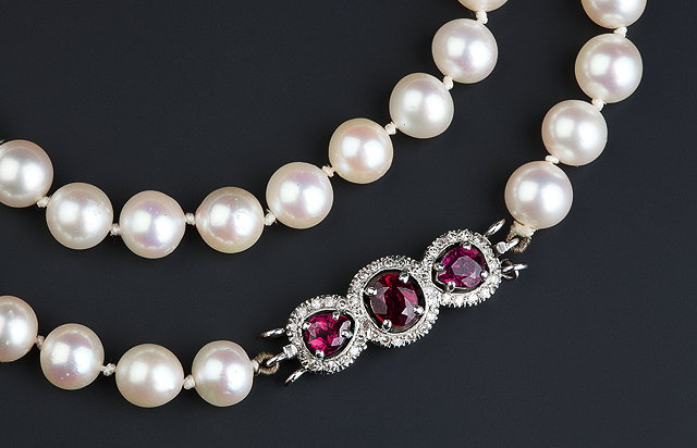 Appraisal: A CULTURED PEARL NECKLACE WITH RUBY AND DIAMOND SET CLASP