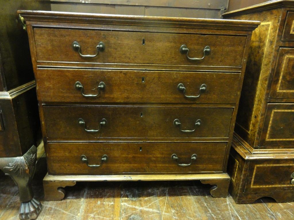 Appraisal: A small Georgian oak chest fitted with four long drawers