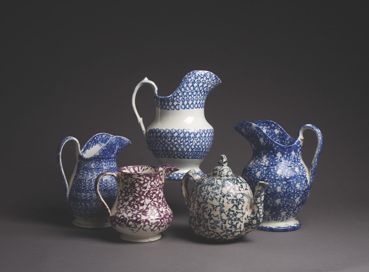 Appraisal: FOUR STONEWARE SPONGE-DECORATED PITCHERS AND A TEAPOT Height of tallest