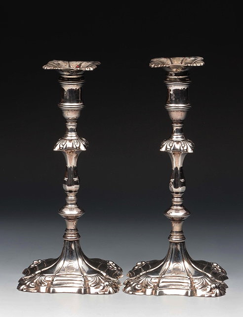 Appraisal: A PAIR OF GEORGE III SILVER CANDLESTICKS on shaped square