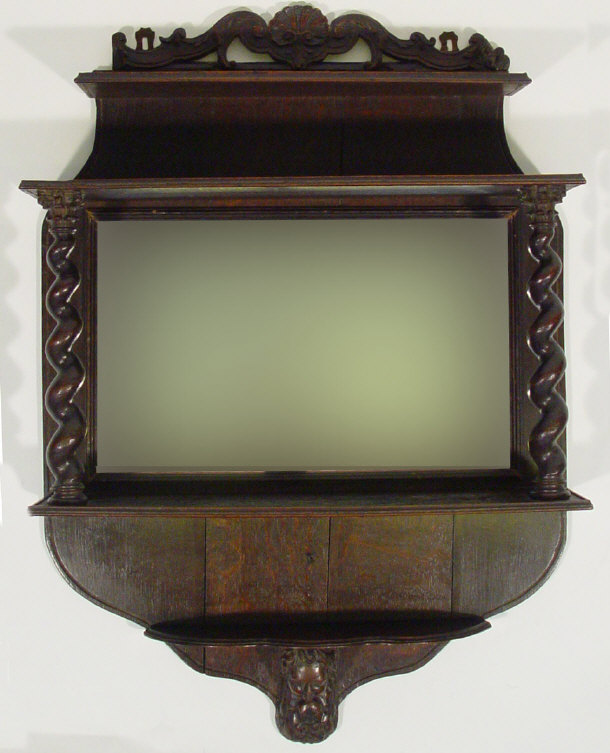 Appraisal: Oak hall mirror the shell carved cornice above open shelf