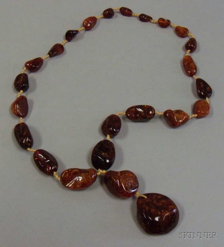 Appraisal: Chinese Amber Necklace composed of a strand of natural beads