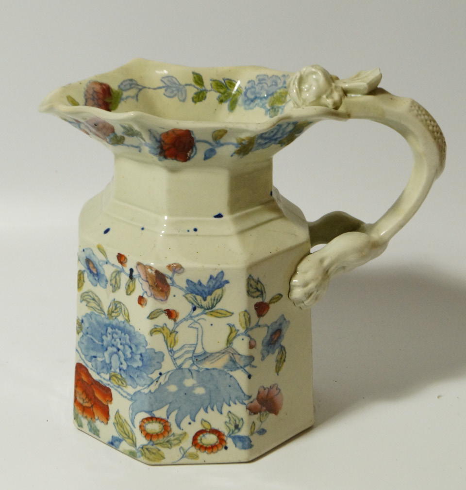 Appraisal: A thC Ironstone pottery jug with shaped outline and elaborate