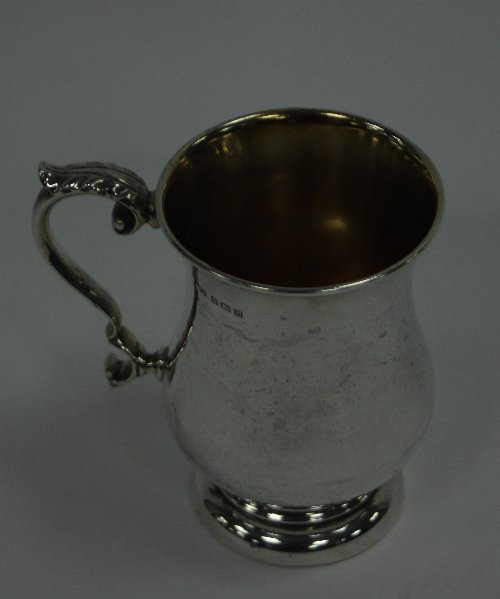 Appraisal: A silver mug Birmingham of baluster form with leaf capped