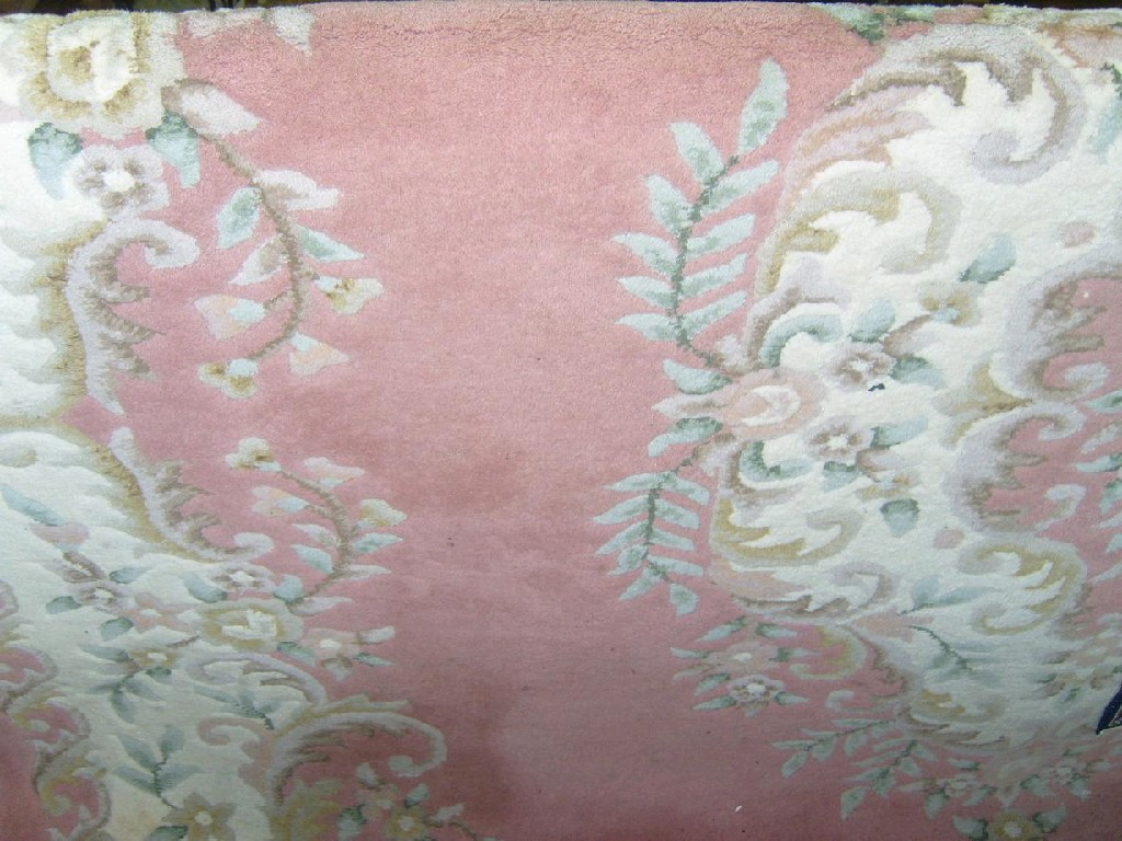 Appraisal: A heavy washed wool carpet with pink field within white