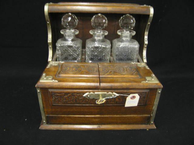 Appraisal: Victorian English Tantilus Cabinet Set trio of cut glass decanters