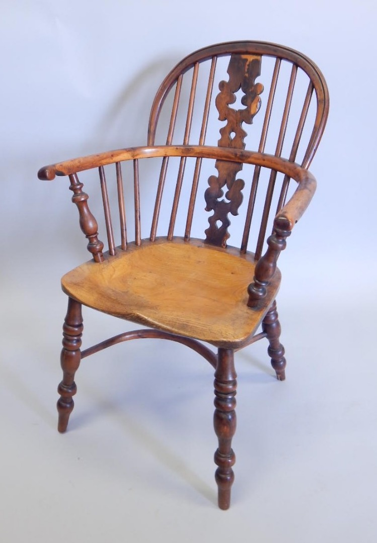 Appraisal: A yew ash and elm Windsor chair with a pierced