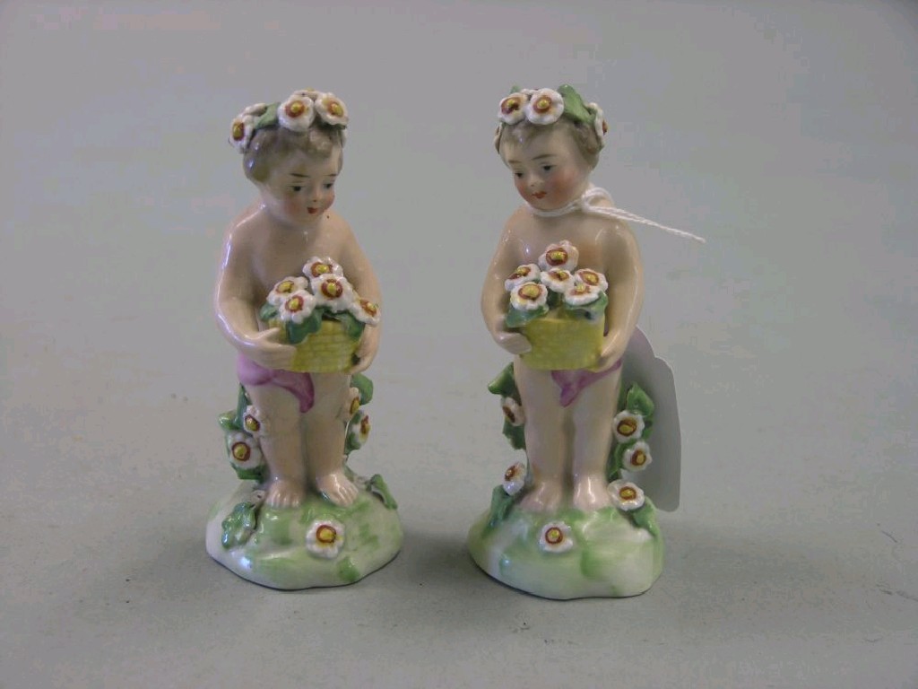 Appraisal: A pair of continental porcelain youths in Derby-style each carrying