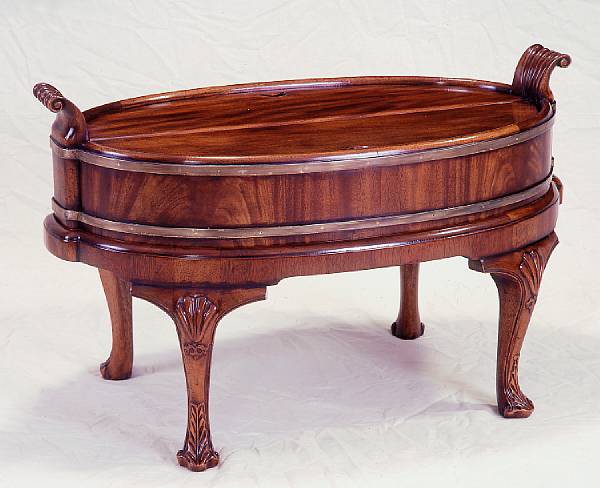 Appraisal: A George III style mahogany wine cooler Overall shell carved